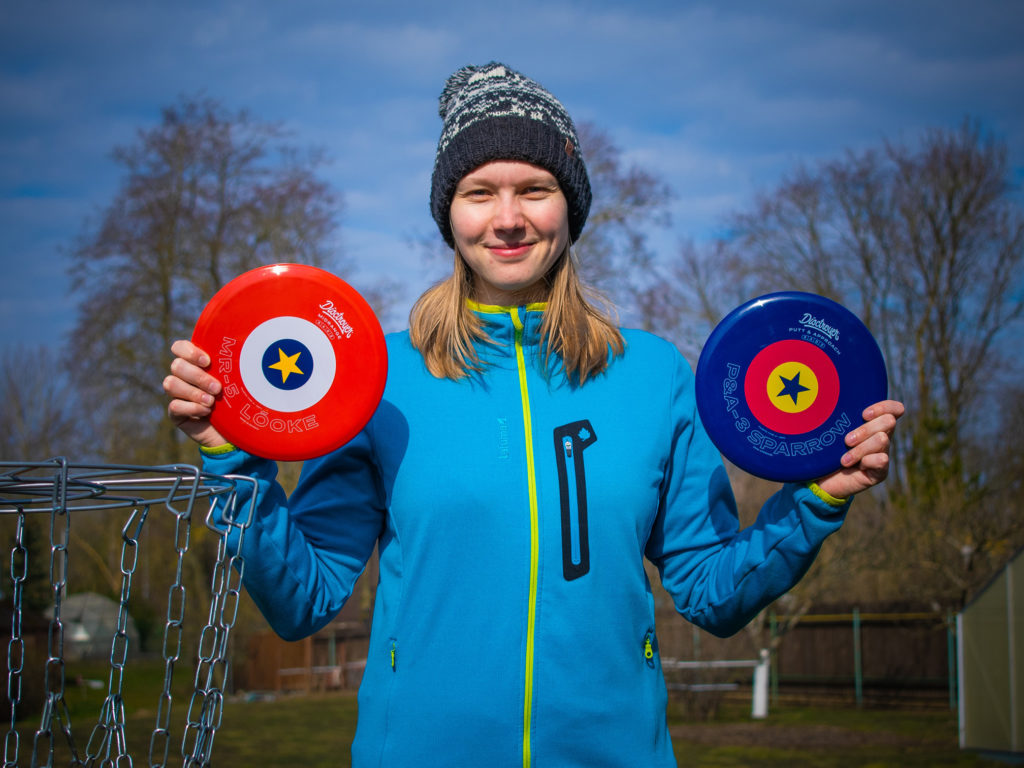 woman holding disc golf discs